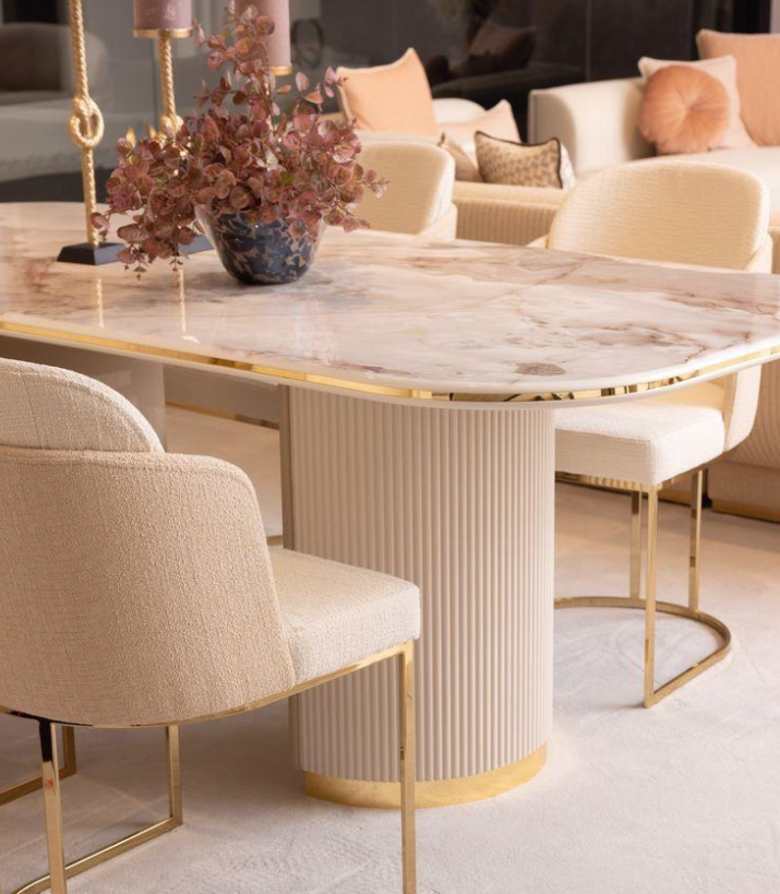 Marble-top dining table with brushed gold accents